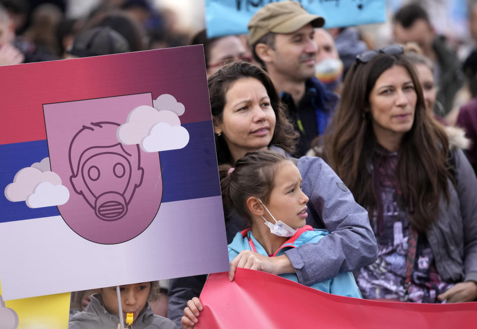 People march during a protest for clean air in Belgrade, Serbia, Sunday, Nov. 28, 2021. Several thousand people have rallied in Belgrade for another environmental protest, a day after demonstrators blocked bridges and roads on several locations in Serbia, and scuffled with riot police who deployed to stop them. (AP Photo/Darko Vojinovic)