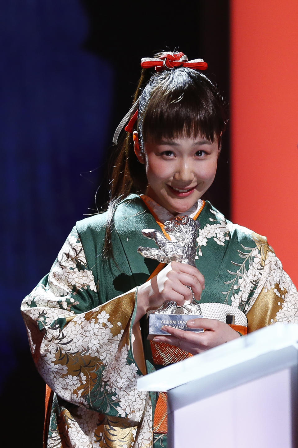 Actress Haru Kuroki receives the Silver Bear as Best Actress for the movie The Little House during the award ceremony at the International Film Festival Berlinale in Berlin, Saturday, Feb. 15, 2014. (AP Photo/Axel Schmidt)