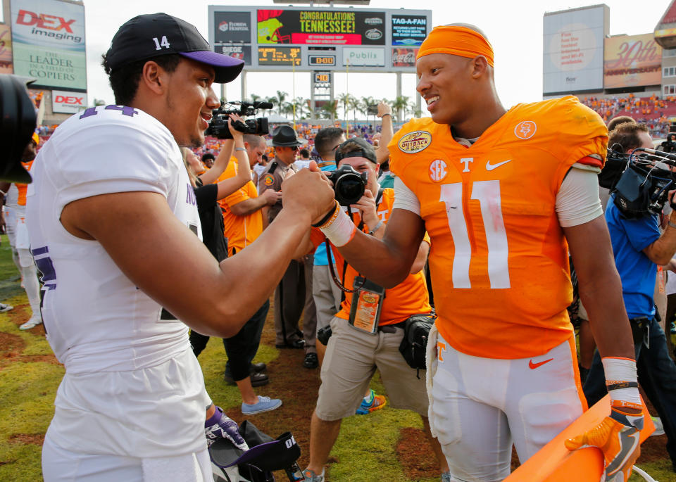 Lloyd Yates (left), pictured on the Outback Bowl in 2016 with Tennessee's Joshua Dobbs, played QB and vast receiver at Northwestern from 2015 to 2017. (Photo by Mike Carlson/Getty Photos)