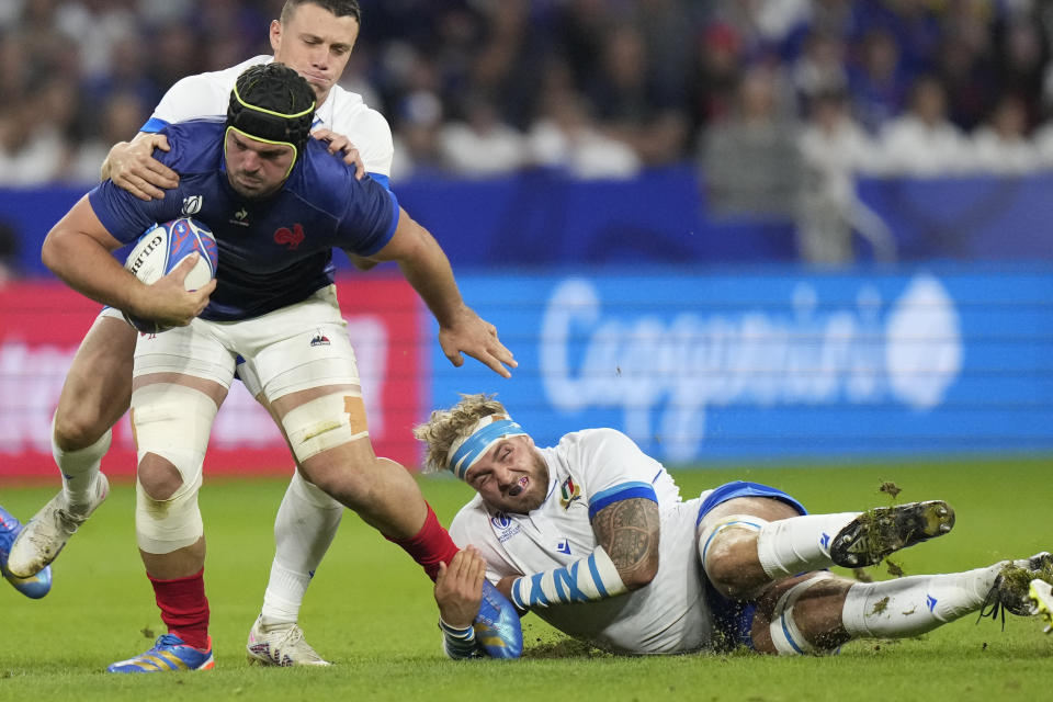 France's Gregory Alldritt is tackled during the Rugby World Cup Pool A match between France and Italy at the OL Stadium in Lyon, France, Friday, Oct. 6, 2023. (AP Photo/Pavel Golovkin)