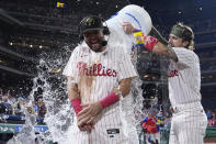 Philadelphia Phillies' Kody Clemens, center, is doused by Bryson Stott after the Phillies won a baseball game against the Washington Nationals, Saturday, May 18, 2024, in Philadelphia. (AP Photo/Matt Slocum)