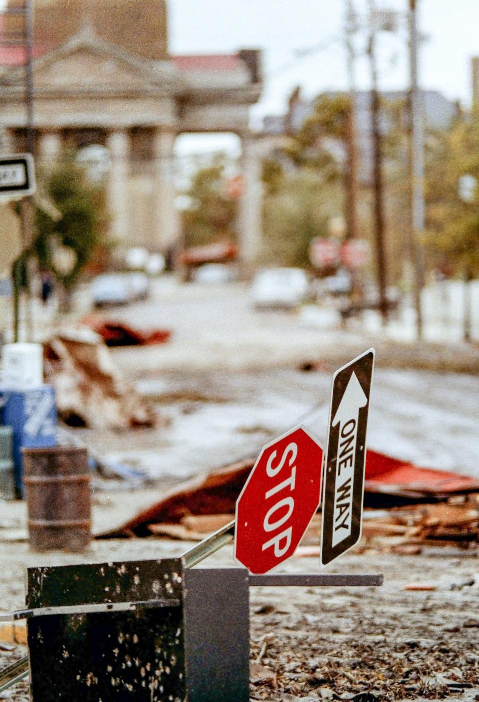 Wind-blown signs near St. Philips Church three days after Hurricane Hugo, standing taller than nearby shops destroyed in September 1989, as seen looking south down Church Street, with back to South Market Street. It was St. Philips Episcopal Church at the time, but is now associated with the worldwide Angelican church.