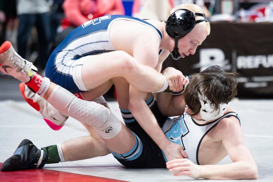 McDowell's Logan Sallot (top) wrestles Seneca Valley's Connor Smith in a 114-pound first round bout at the PIAA Class 3A Wrestling Championships at the Giant Center on March 9, 2023, in Derry Township. Sallot won by decision, 4-2.