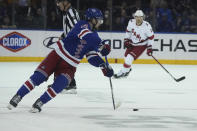 New York Rangers left wing Alexis Lafrenière (13) controls the puck against Carolina Hurricanes during the first period of a NHL hockey game, Tuesday, April 12, 2022, in New York. (AP Photo/Bebeto Matthews)