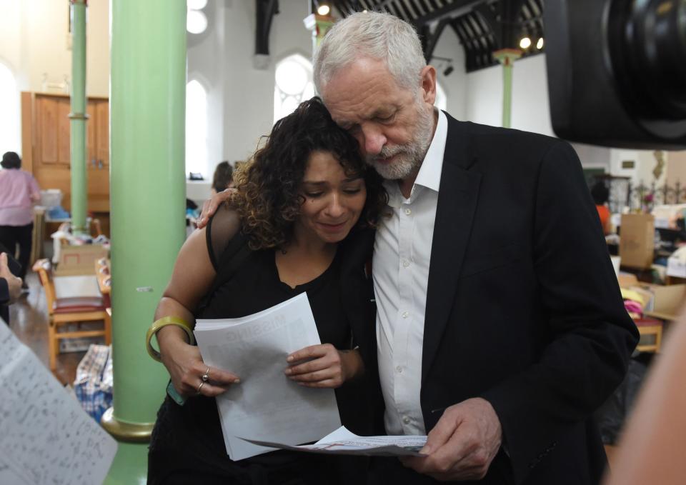 Labour leader Jeremy Corbyn comforts a local resident (name not given) at St Clement's Church in west London where volunteers have provided shelter and support for people affected by the fire at Grenfell Tower. (PA Images)