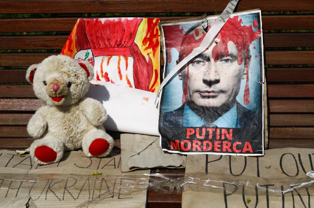 <span class="caption">A sign reading 'Putin, murderer' is shown during a protest in Krakow, Poland, on May 8, 2022. </span> <span class="attribution"><a class="link " href="https://www.gettyimages.com/detail/news-photo/banner-reading-putin-murderer-is-seen-during-rape-is-a-war-news-photo/1240544629" rel="nofollow noopener" target="_blank" data-ylk="slk:Beata Zawrzel/NurPhoto via Getty Images;elm:context_link;itc:0;sec:content-canvas">Beata Zawrzel/NurPhoto via Getty Images</a></span>