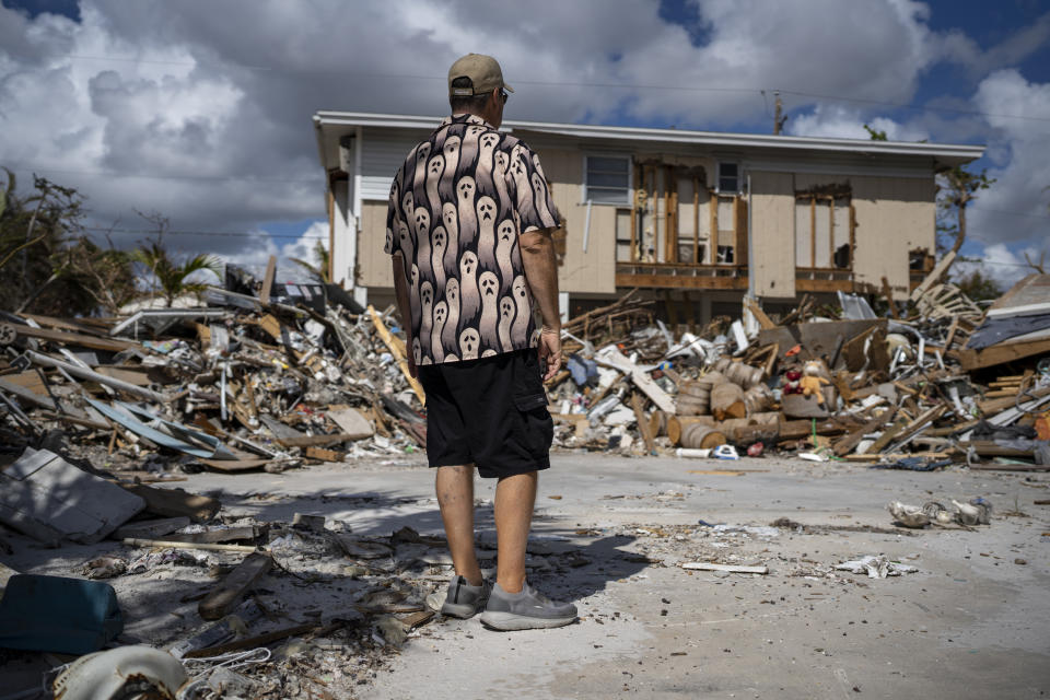 Michael Yost at the damaged home he was renting on Fort Myers Beach, Fla. one month after Hurricane Ian ravaged the area. (Thomas Simonetti for NBC News)