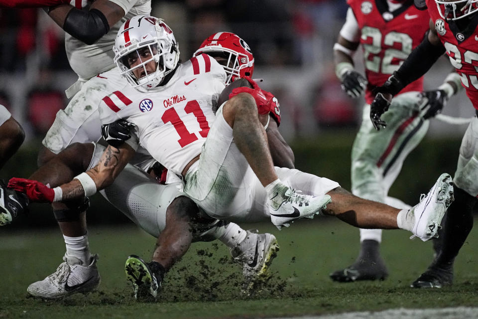 Mississippi wide receiver Jordan Watkins (11) is tackled by Georgia linebacker C.J. Allen (33) during the second half of an NCAA college football game, Saturday, Nov. 11, 2023, in Athens, Ga. (AP Photo/John Bazemore)
