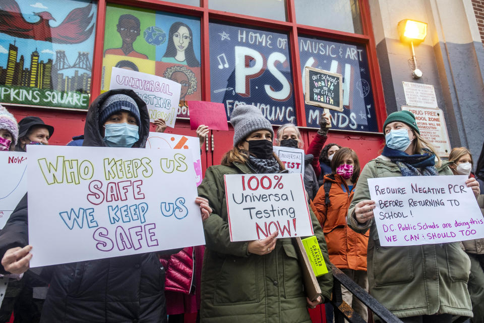 FILE — Teachers from the Earth School speak out on issues related to lack of COVID testing outside P.S. 64, Dec. 21, 2021, in New York. In a reversal, New York Mayor Eric Adams is considering a remote option for schools. (AP Photo/Brittainy Newman, File)