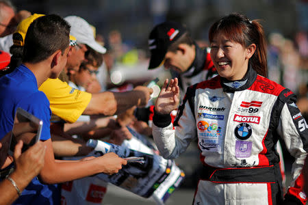 FILE PHOTO : Keiko Ihara of Japan waves during a parade on the eve of the 82th 24-hours Le Mans endurance race in Le Mans, June 13, 2014. REUTERS/Stephane Mahe/File Photo