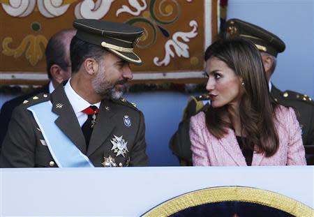 Spain's Crown Prince Felipe (L) and Spain's Princess Letizia attend a military parade marking Spain's National Day in Madrid October 12, 2013. REUTERS/Juan Medina