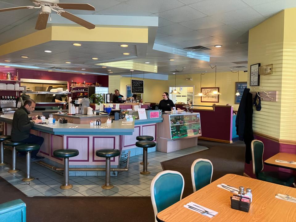 Michael's A.M. has a cozy and colorful interior that fosters an old-school diner vibe. Customers can sit at the bar or enjoy their meal at a table or booth.