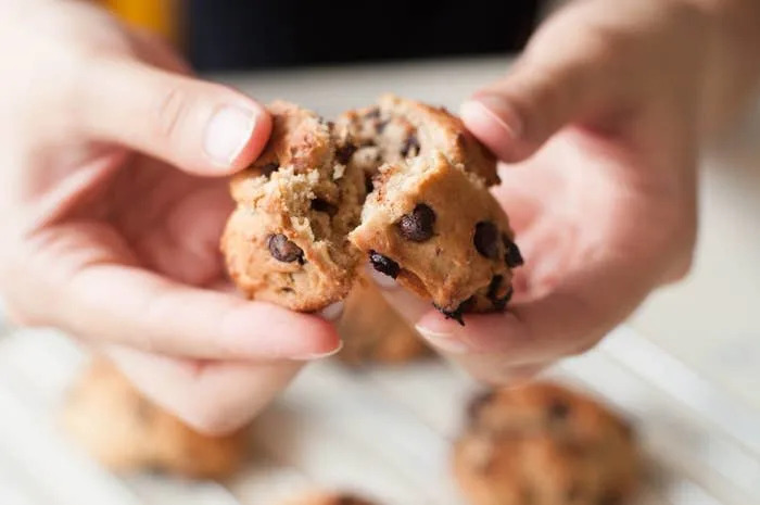 Ripping into a freshly baked chocolate chip cookie.