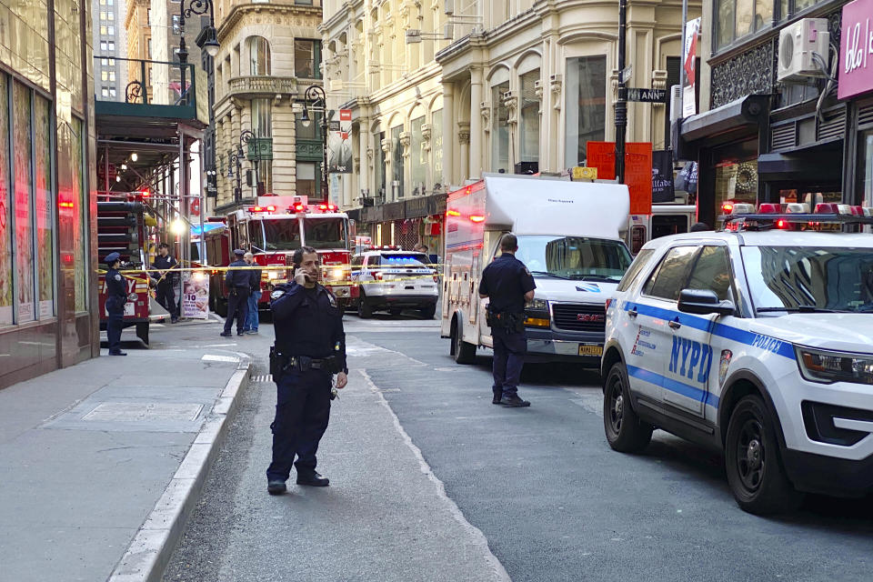 New York City Police and Fire Department personnel cordon off an area in New York's Financial District, Tuesday, April 18, 2023, near the site of a partially collapsed parking garage. It wasn't immediately clear whether anyone was injured. (AP Photo/Julie Jacobson)