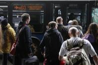 People wait to board public transportation outside the central terminal of LaGuardia Airport in the Queens borough of New York April 8, 2014. REUTERS/Shannon Stapleton