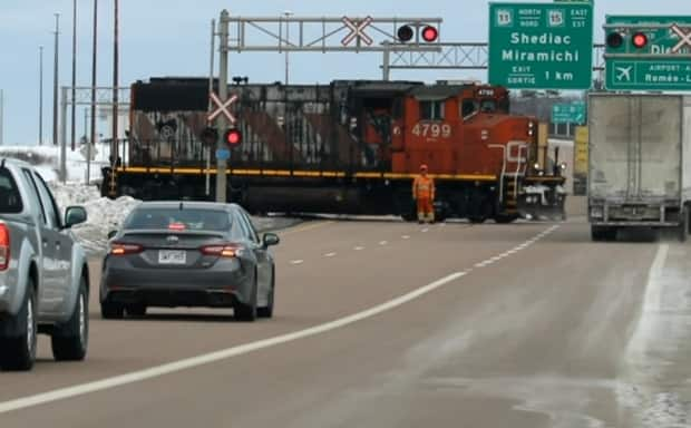 Traffic was closed on the Trans-Canada Highway on Saturday after a CN locomotive slid off the tracks. (Submitted by Wayne Perry - image credit)