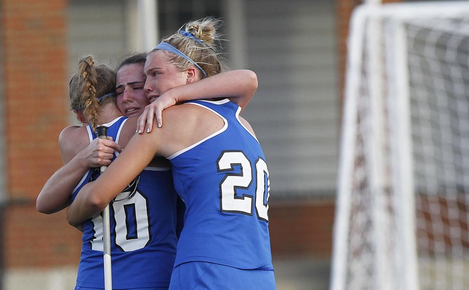 Olentangy Liberty's Ellie Hoying, Makena Harrington and Sid Struck embrace following the Patriots' 14-11 loss at New Albany in the Division I, Region 3 final May 25.