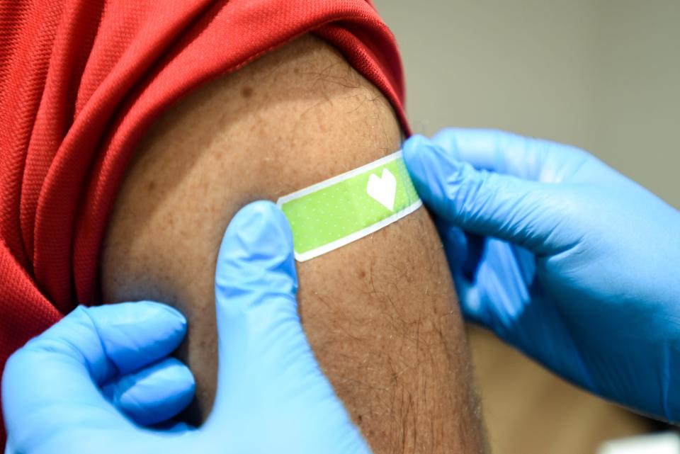 A CVS health leader gets a flu shot as the team goes through the CVS process for COVID-19 and flu shots. (Photo Phil Didion)