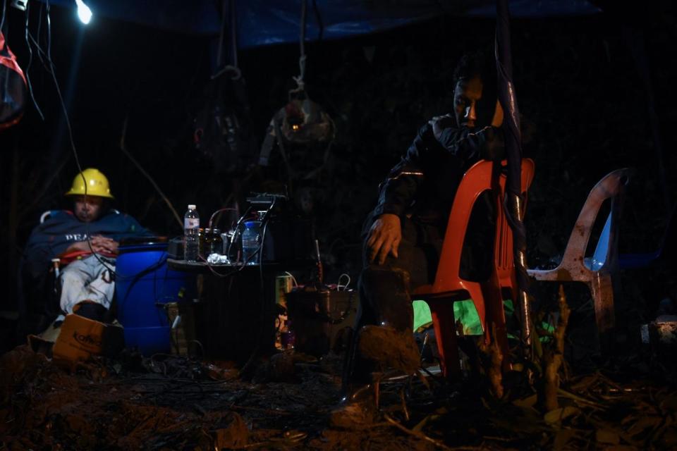 Search: Technicians rest near the mouth of Tham Luang cave during the rescue effort (AFP/Getty Images)