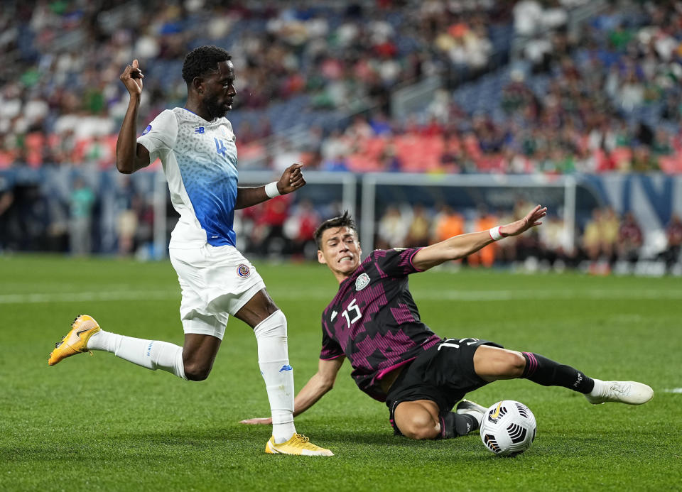 Costa Rica's Keysher Fuller (4) and Mexico's Héctor Moreno (15) go after the ball during the first half of a CONCACAF Nations League soccer semifinal Thursday, June 3, 2021, in Denver. (AP Photo/Jack Dempsey)