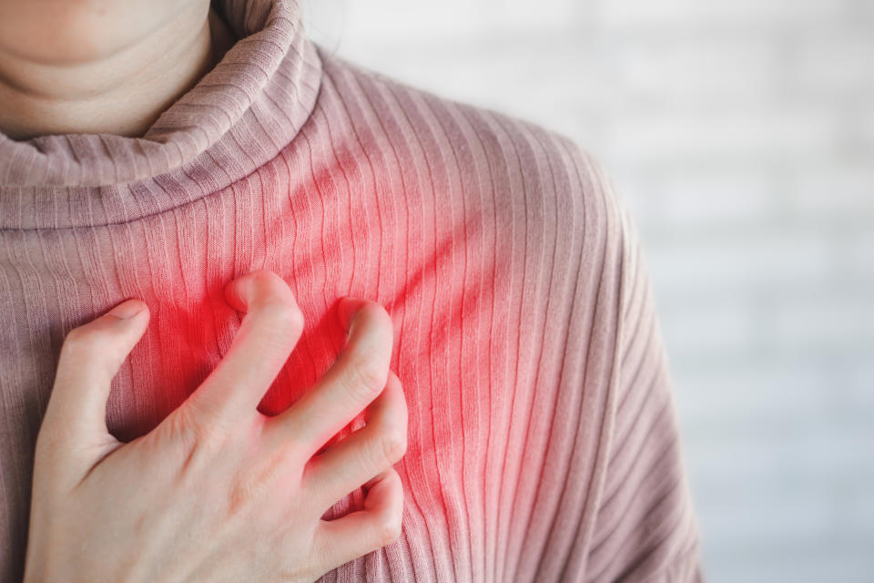 Asian woman hand touching her chest  having heart attack, healthcare and medical concept