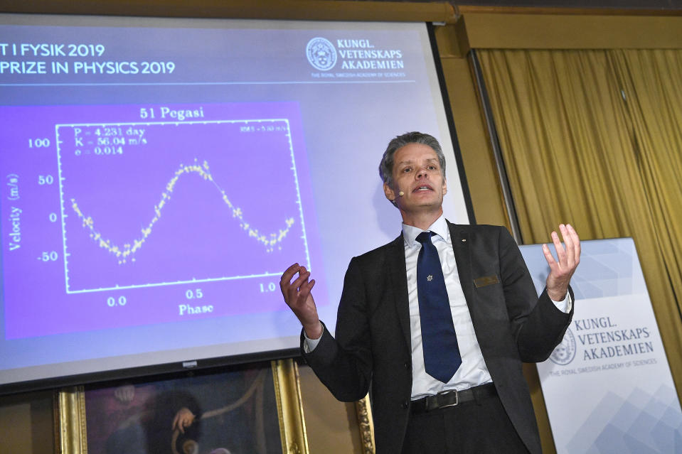 Ulf Danielsson, member of the Nobel committee talks during the announcement of the winners of the 2019 Nobel Prize in Physics during news conference at the Royal Swedish Academy of Sciences in Stockholm, Sweden, on Tuesday Oct. 8, 2019. The 2019 Nobel Prize in Physics is awarded to James Peebles, Michel Mayor and Didier Queloz. (Claudio Bresciani / TT via AP)