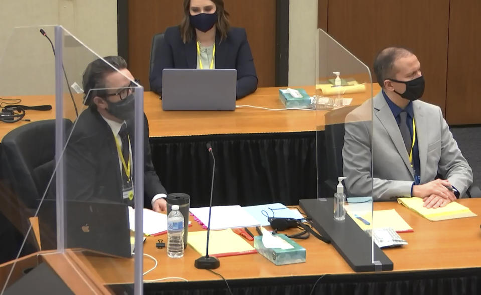 In this screen grab from video, defense attorney Eric Nelson, left, defendant former Minneapolis police officer Derek Chauvin, right, and Nelson's assistant Amy Voss, back, listen as Hennepin County Judge Peter Cahill presides over jury selection in the trial of Chauvin Wednesday, March 17, 2021 at the Hennepin County Courthouse in Minneapolis, Minn. Chauvin is charged in the May 25, 2020 death of George Floyd. (Court TV, via AP, Pool)