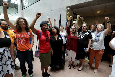 Protesters voice their opposition to U.S. President Donald Trump's Supreme Court nominee Brett Kavanaugh and their support for Dr. Christine Blasey Ford, the woman who has accused Kavanaugh of sexual assault, during a demonstration on Capitol Hill in Washington, U.S., September 20, 2018. REUTERS/Yuri Gripas