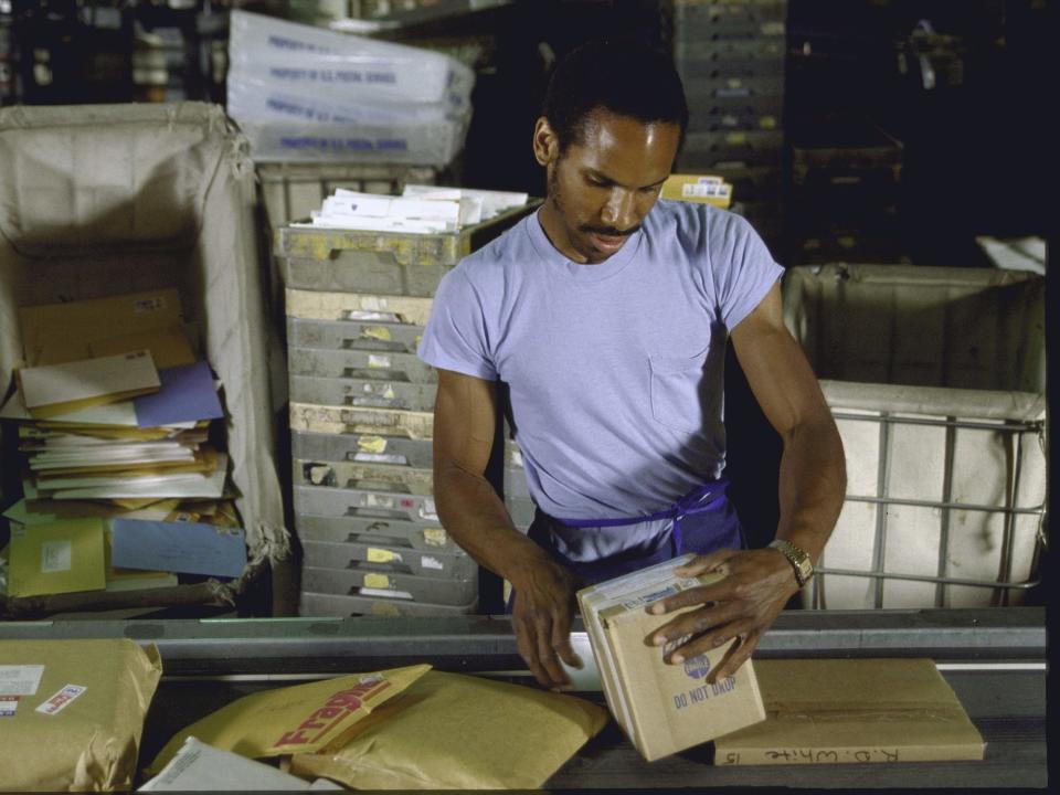 A postal worker in a warehouse in 1988