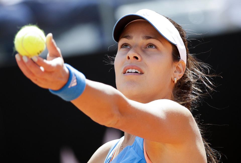 Ana Ivanovic of Serbia serves to Maria Sharapova of Russia during their women's singles match at the Rome Masters tennis tournament May 15, 2014. REUTERS/Max Rossi (ITALY - Tags: SPORT TENNIS)