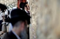 <p>Ultra-Orthodox Jewish men pray at the Western Wall in the Old City of Jerusalem on the eve of Yom Kippur also known as the Day of Atonement, the holiest day of the year in Judaism, on on Sept. 28, 2017. (Photo: Thomas Coex/AFP/Getty Images) </p>