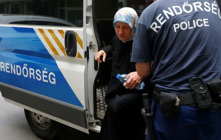 Police aid Fattoum Hassan, a Syrian migrant who was put on trial for illegal border crossing, ahead of her court sentencing in Szeged, Hungary, July 1, 2016. REUTERS/Laszlo Balogh