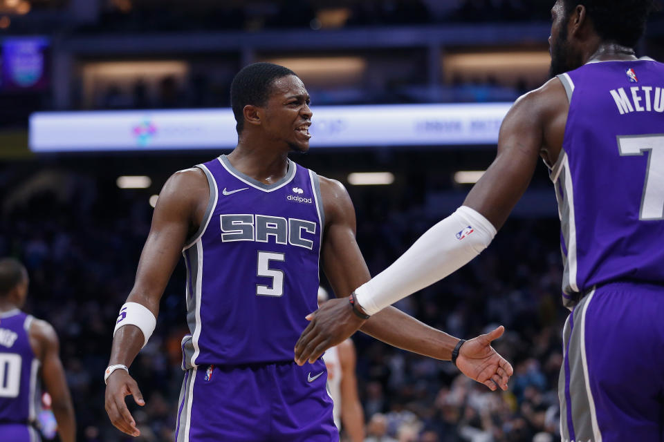 SACRAMENTO, CALIFORNIA - NOVEMBER 08: De'Aaron Fox #5 celebrates with Chimezie Metu #7 of the Sacramento Kings after a play in the second half against the Phoenix Suns at Golden 1 Center on November 08, 2021 in Sacramento, California. NOTE TO USER: User expressly acknowledges and agrees that, by downloading and/or using this photograph, User is consenting to the terms and conditions of the Getty Images License Agreement. (Photo by Lachlan Cunningham/Getty Images)