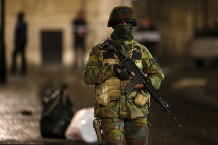 A Belgian soldier patrols along a street during a continued high level of security following the recent deadly Paris attacks, in Brussels, Belgium, November 22, 2015. REUTERS/Youssef Boudlal