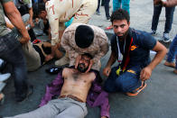 <p>Protesters overcome by tear gas lie on the ground after anti-government protesters tried to approach the heavily fortified Green Zone at Tahrir Square in Baghdad, Iraq, May 27, 2016. (Reuters/Khalid al Mousily) </p>