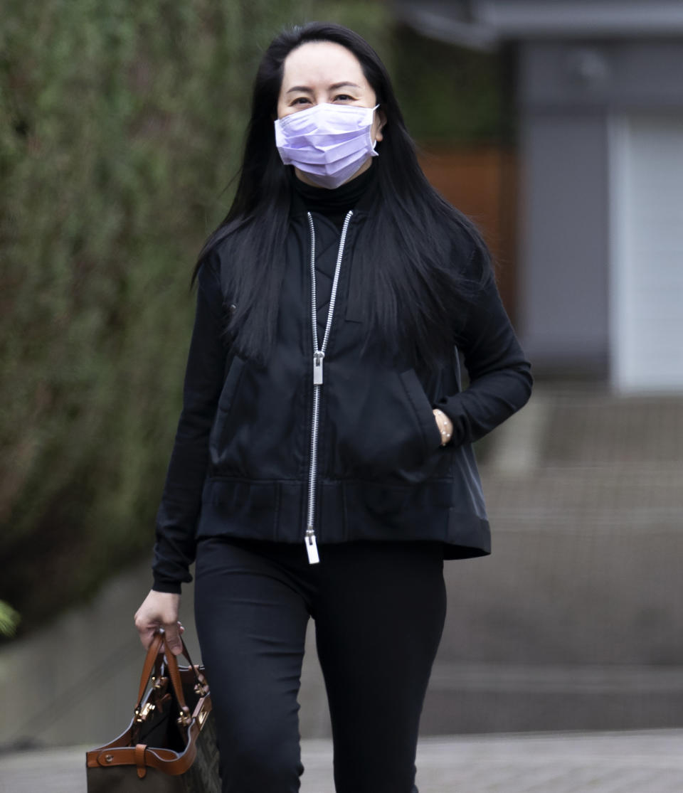 Chief Financial Officer of Huawei, Meng Wanzhou leaves her home in Vancouver, British Columbia, to go to the British Columbia Supreme Court on Friday, Jan. 29, 2021. (Jonathan Hayward/The Canadian Press via AP)