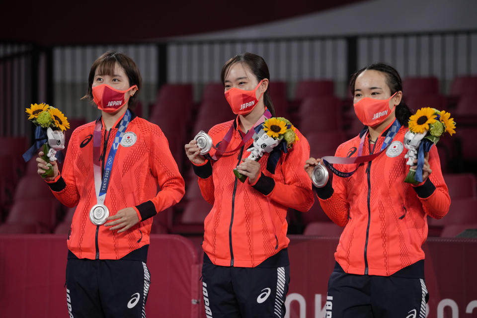 From left, silver medalists Miu Hirano, Kasumi Ishikawa, and Mima Ito of Japan pose with their medals during the medal ceremony for women's team table tennis at the 2020 Summer Olympics, Thursday, Aug. 5, 2021, in Tokyo. (AP Photo/Kin Cheung)