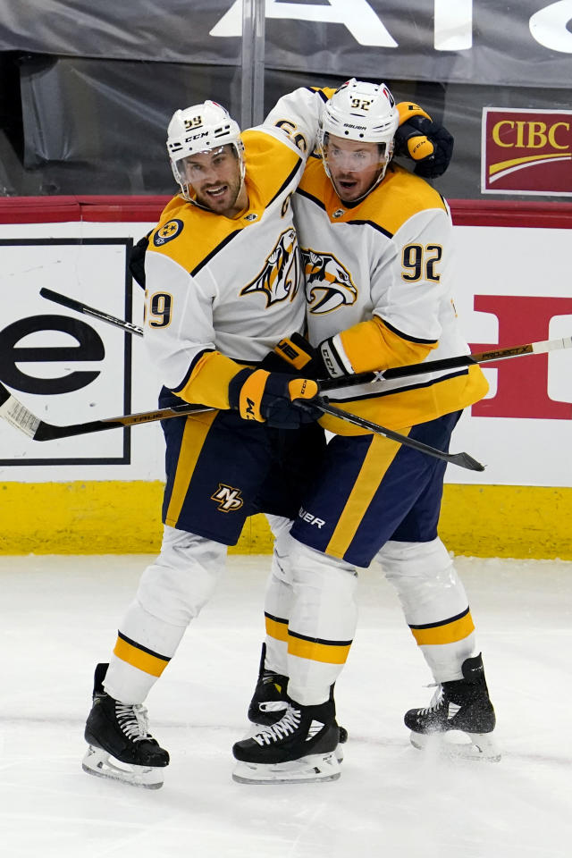 Chicago Blackhawks center Kirby Dach, right, celebrates his tying