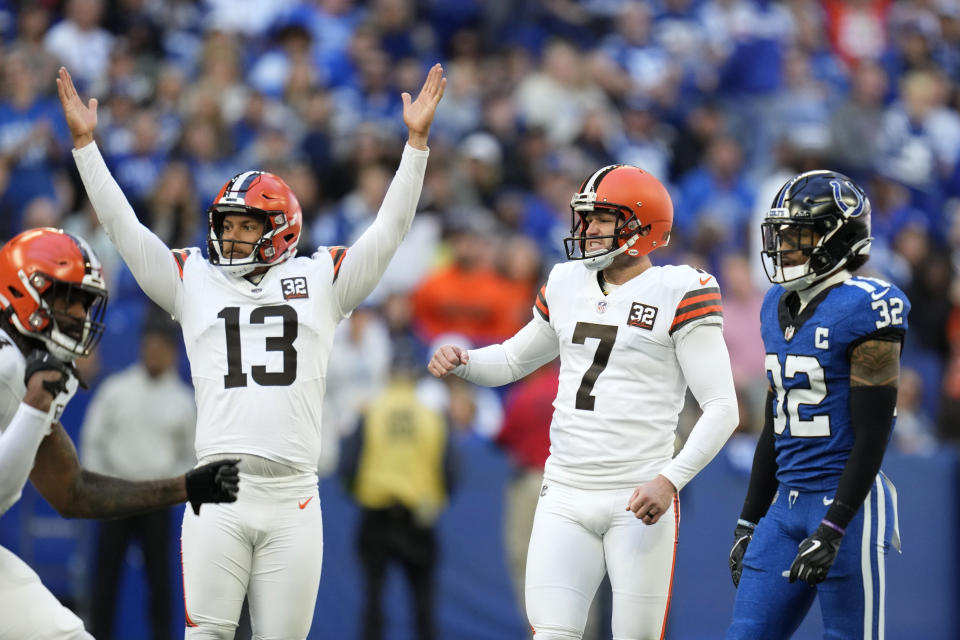 Cleveland Browns place-kicker Dustin Hopkins (7) and teammate Corey Bojorquez (13) react in front of Indianapolis Colts safety Julian Blackmon (32) after kicking a 54-yard field goal during the second half of an NFL football game, Sunday, Oct. 22, 2023, in Indianapolis. (AP Photo/Michael Conroy)