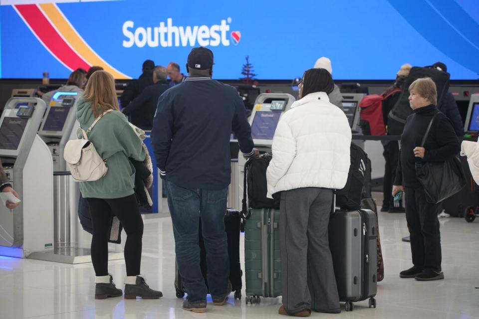 Mandatory Credit: Photo by David Zalubowski/AP/Shutterstock (13689212k) Travelers queue up at the check-in counters for Southwest Airlines in Denver International Airport, in Denver Winter Weather Travel, Denver, United States - 30 Dec 2022