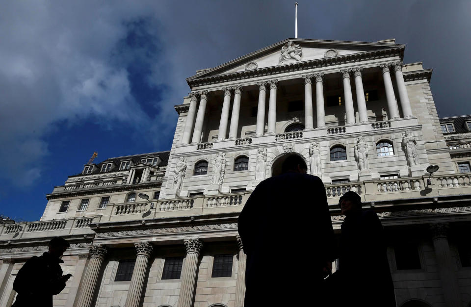 City workers walk past the Bank of England in London. Photo: Toby Melville/Reuters