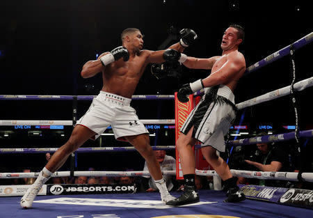 Boxing - Anthony Joshua vs Joseph Parker - World Heavyweight Title Unification Fight - Principality Stadium, Cardiff, Britain - March 31, 2018 Anthony Joshua in action with Joseph Parker Action Images via Reuters/Andrew Couldridge