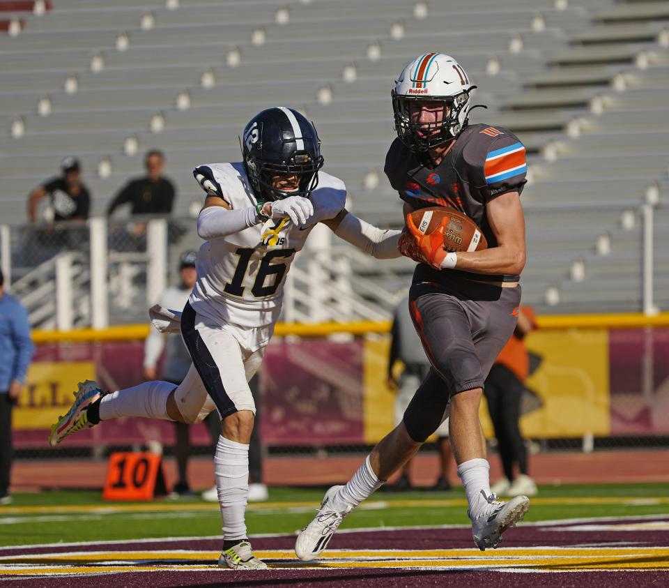 November 19, 2022; Phoenix, Ariz; USA; Eastmark wide out Austin Johnston (11) makes a touchdown reception against Pusch Ridge during a 3A playoff game at Mountain Pointe High School