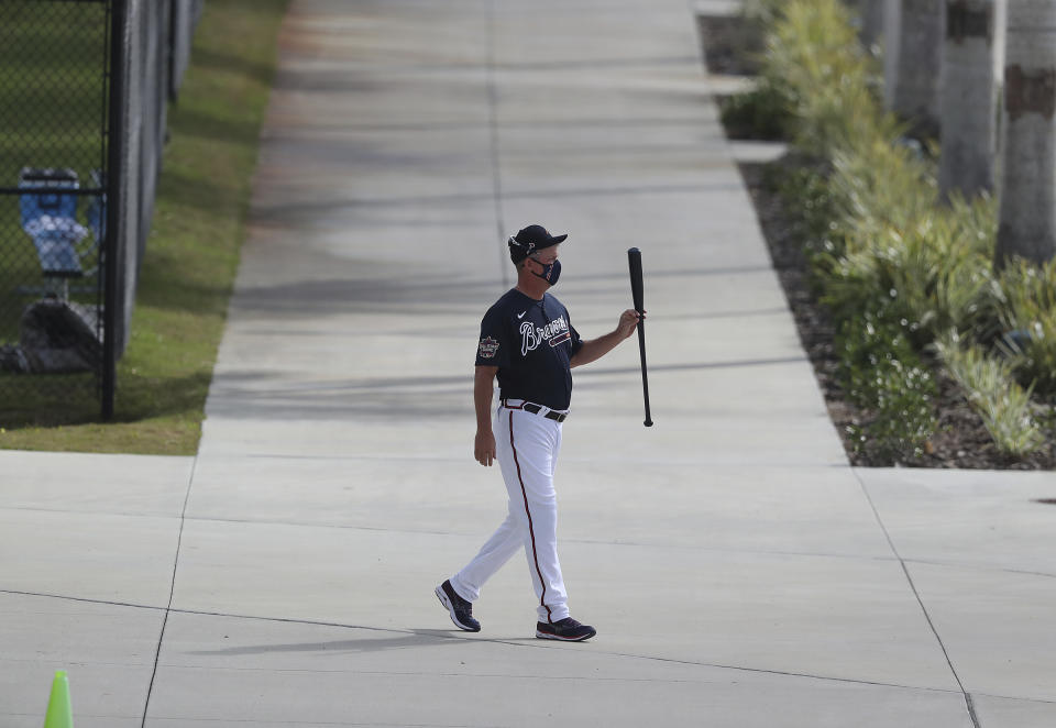 Atlanta Braves Hall of Famer Chipper Jones leaves the batting cages twirling his bat after a morning session of batting practice during baseball spring training, Wednesday, Feb. 24, 2021, in North Port, Fla. (Curtis Compton/Atlanta Journal-Constitution via AP)