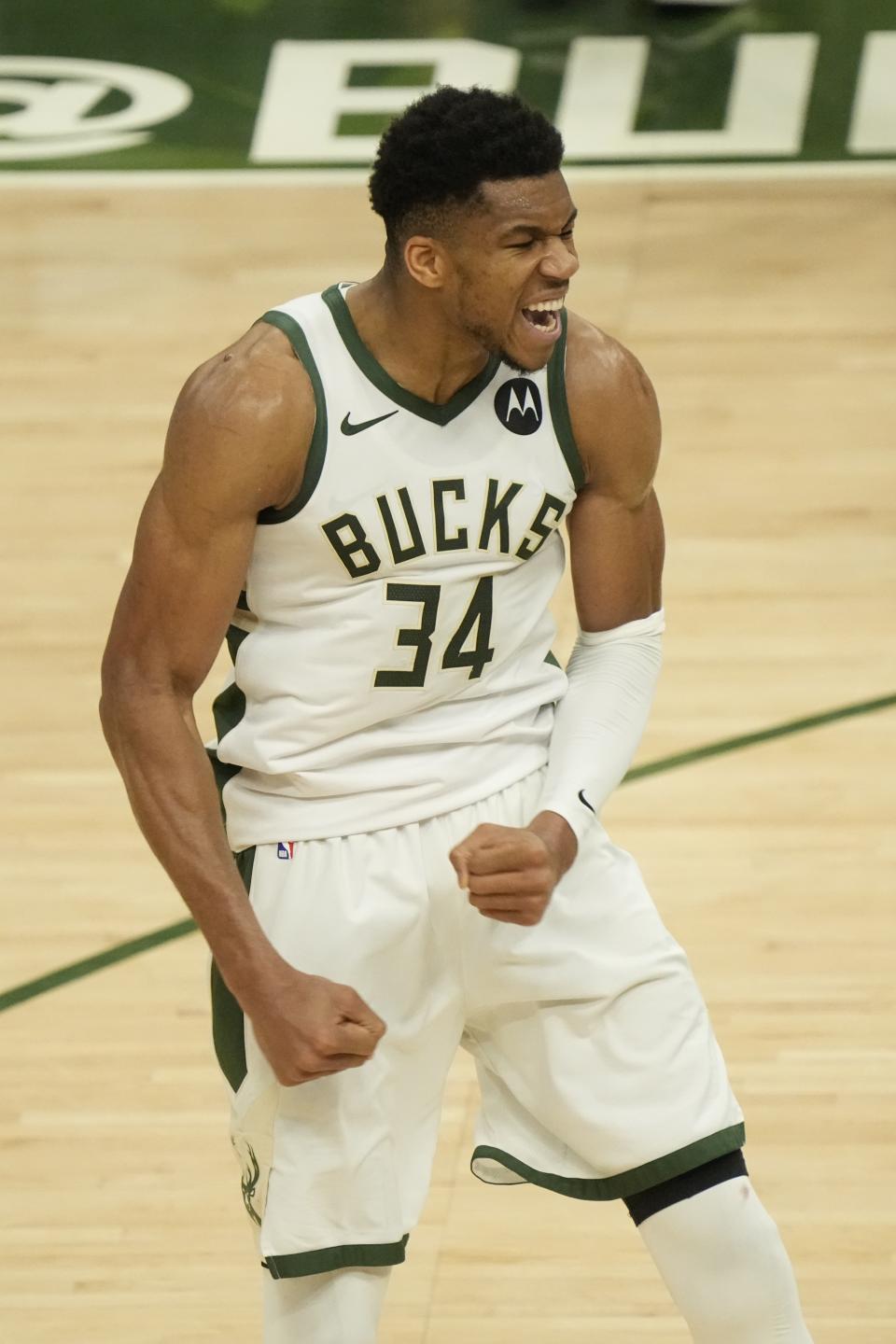 Milwaukee Bucks' Giannis Antetokounmpo reacts after teammate Khris Middleton made a three-point basket during the second half of Game 4 of the NBA Eastern Conference basketball semifinals game against the Brooklyn Nets Sunday, June 13, 2021, in Milwaukee. (AP Photo/Morry Gash)
