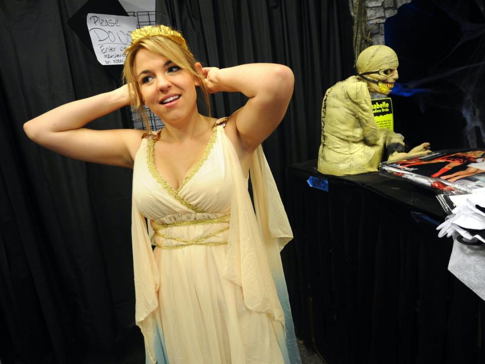 A woman tries on costumes at Spirit Halloween.