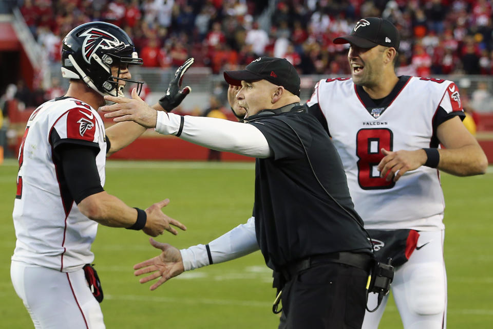 Atlanta Falcons head coach Dan Quinn, center, celebrates with quarterbacks Matt Ryan, left, and Matt Schaub (8) during the second half of an NFL football game against the San Francisco 49ers in Santa Clara, Calif., Sunday, Dec. 15, 2019. (AP Photo/John Hefti)