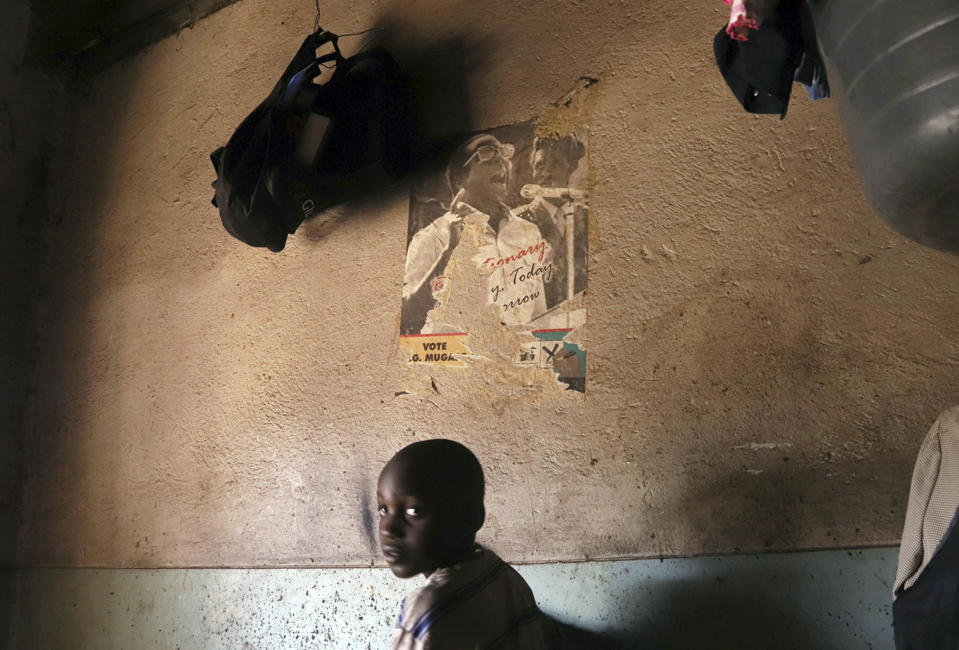 A young child walks past a poster of former Zimbabwean President Robert Mugabe in a building in Harare Friday, Sept. 6, 2019. Mugabe, the former leader of Zimbabwe forced to resign in 2017 after a 37-year rule whose early promise was eroded by economic turmoil, disputed elections and human rights violations, has died. He was 95. (AP Photo)