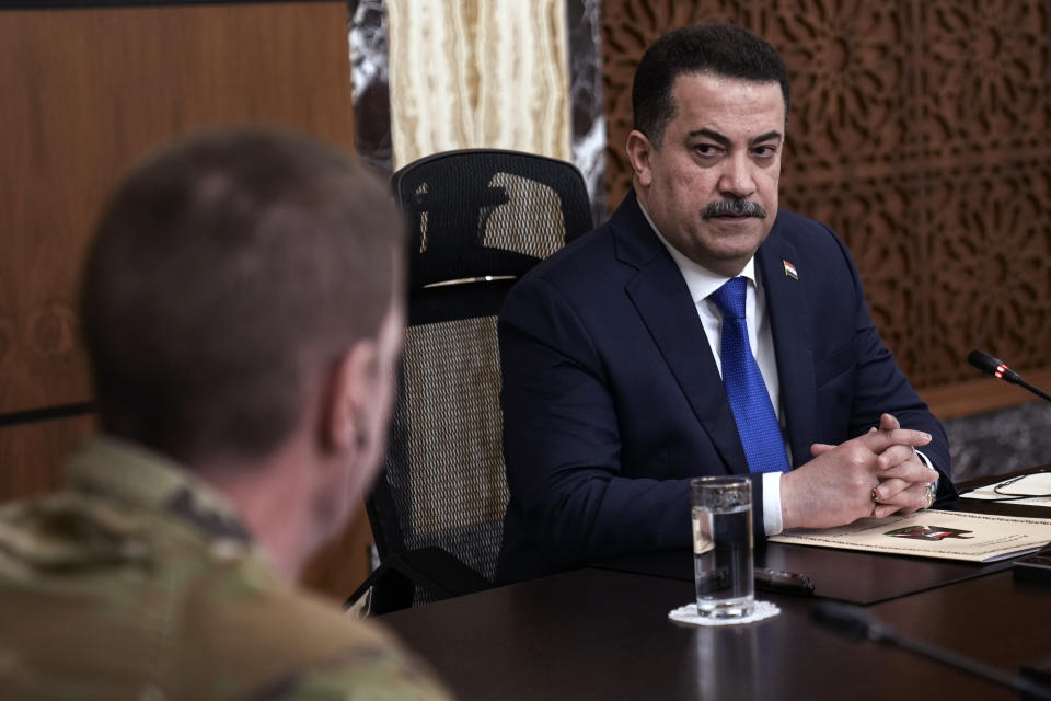 Iraqi Prime Minister Mohammed Shia al-Sudani, right, chairs the first session of negotiations between Iraq and the United States to wind down the International Coalition mission in Baghdad, Iraq, Saturday, Jan. 27, 2024. (AP Photo/Hadi Mizban, Pool)