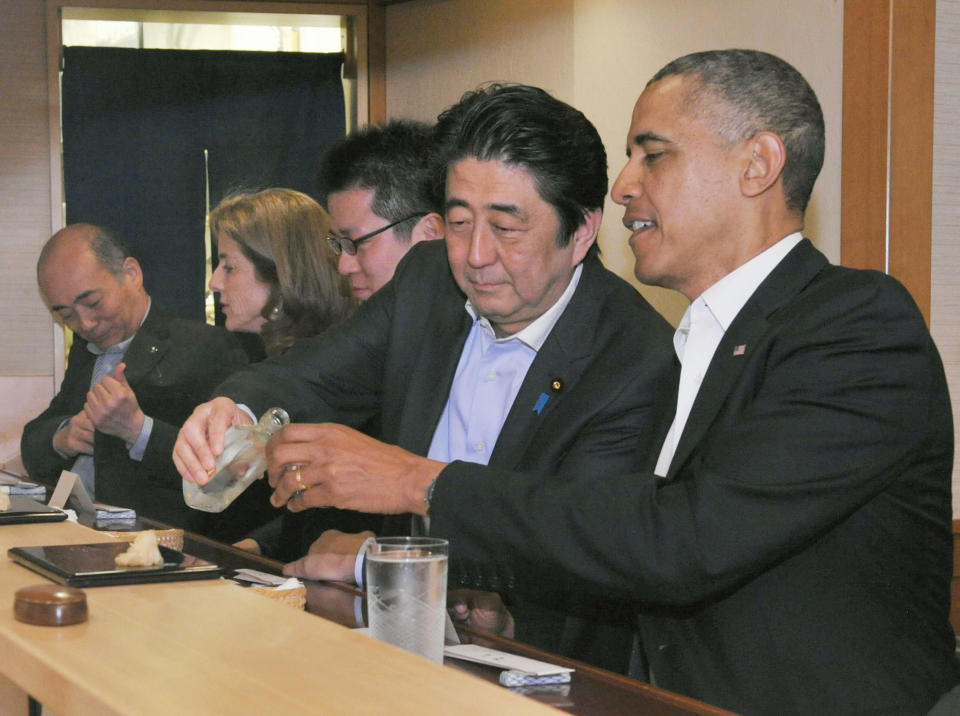 Japanese Prime Minister Shizo Abe fills U.S. President Barak Obama's glass during dinner at Sukiyabashi Jiro sushi restaurant in Tokyo on April 23, 2014. (Photo: Kyodo News via Getty Images)